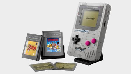 Full view of Lego Game Boy kit next to Zelda and Mario cartridges and swappable inserts.