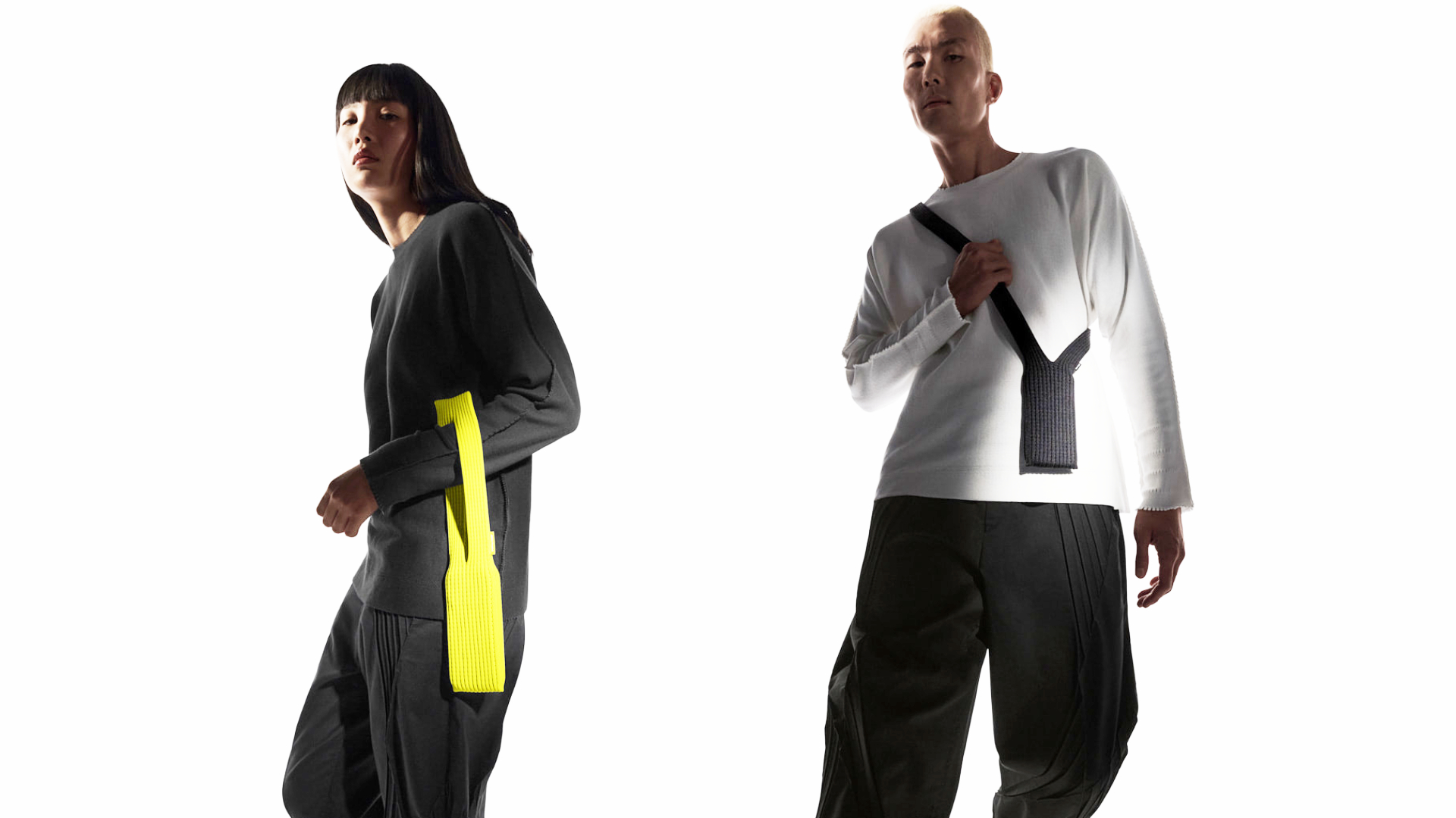 Two people modelling the iPhone Pocket, with one wearing it over an arm and the other wearing it around their shoulder