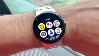 Google Pixel Watch 3 on a person's wrist showing the apps list