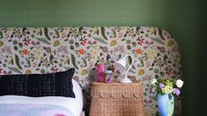 green bedroom with floral headboard