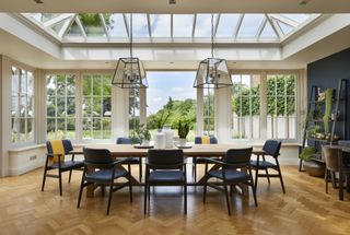orangery ideas dining space with modern industrial black pendants and open shelving by Westbury Garden Rooms
