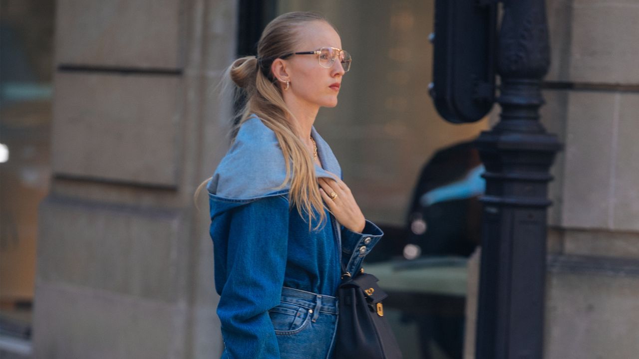 Woman wearing a denim shirt outfit.