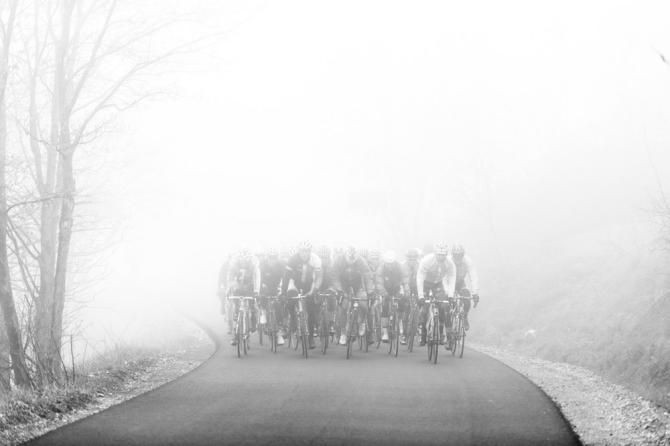 The gruppetto emerges out of the fog en route to the Giro's mountaintop finish at Jafferau.