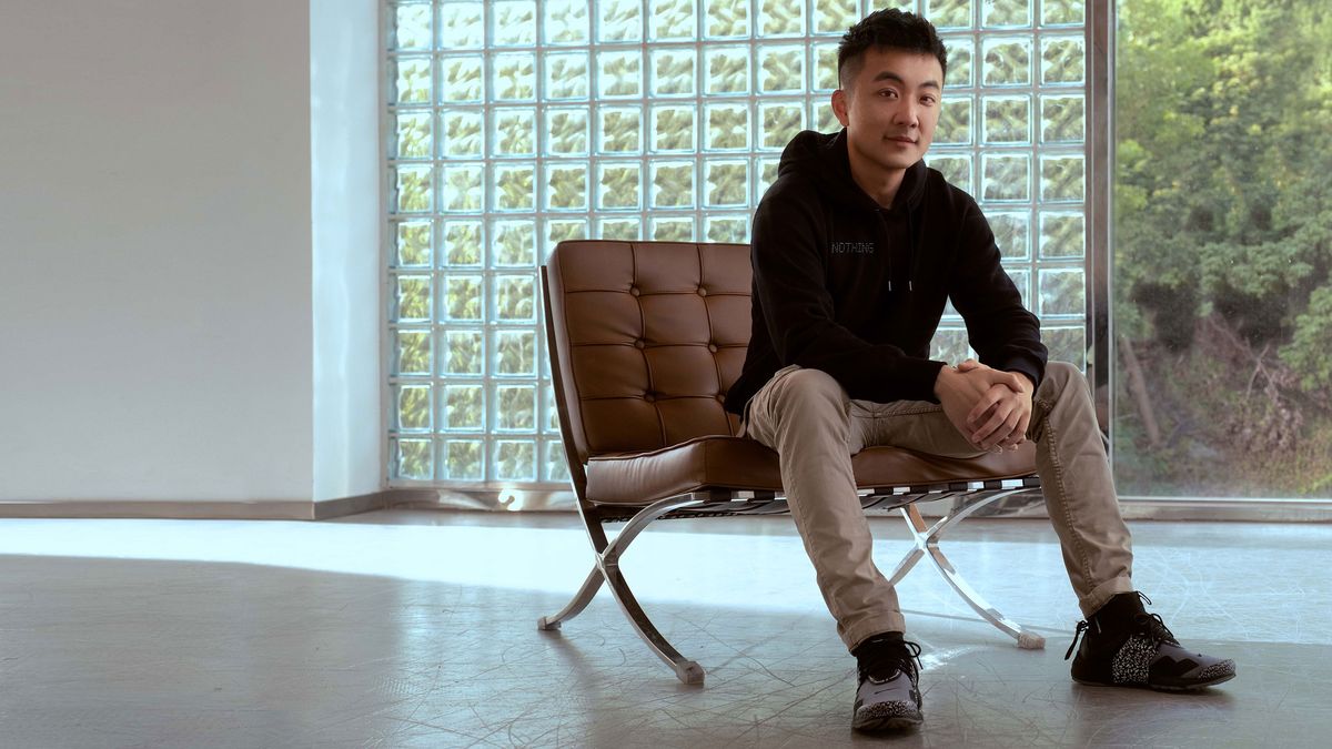 A young man sitting up in an informal chair