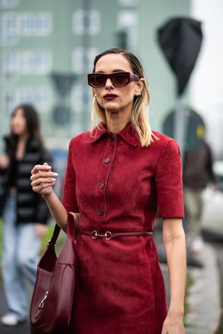 woman in a red dress with dark red lipstick and two tone hair