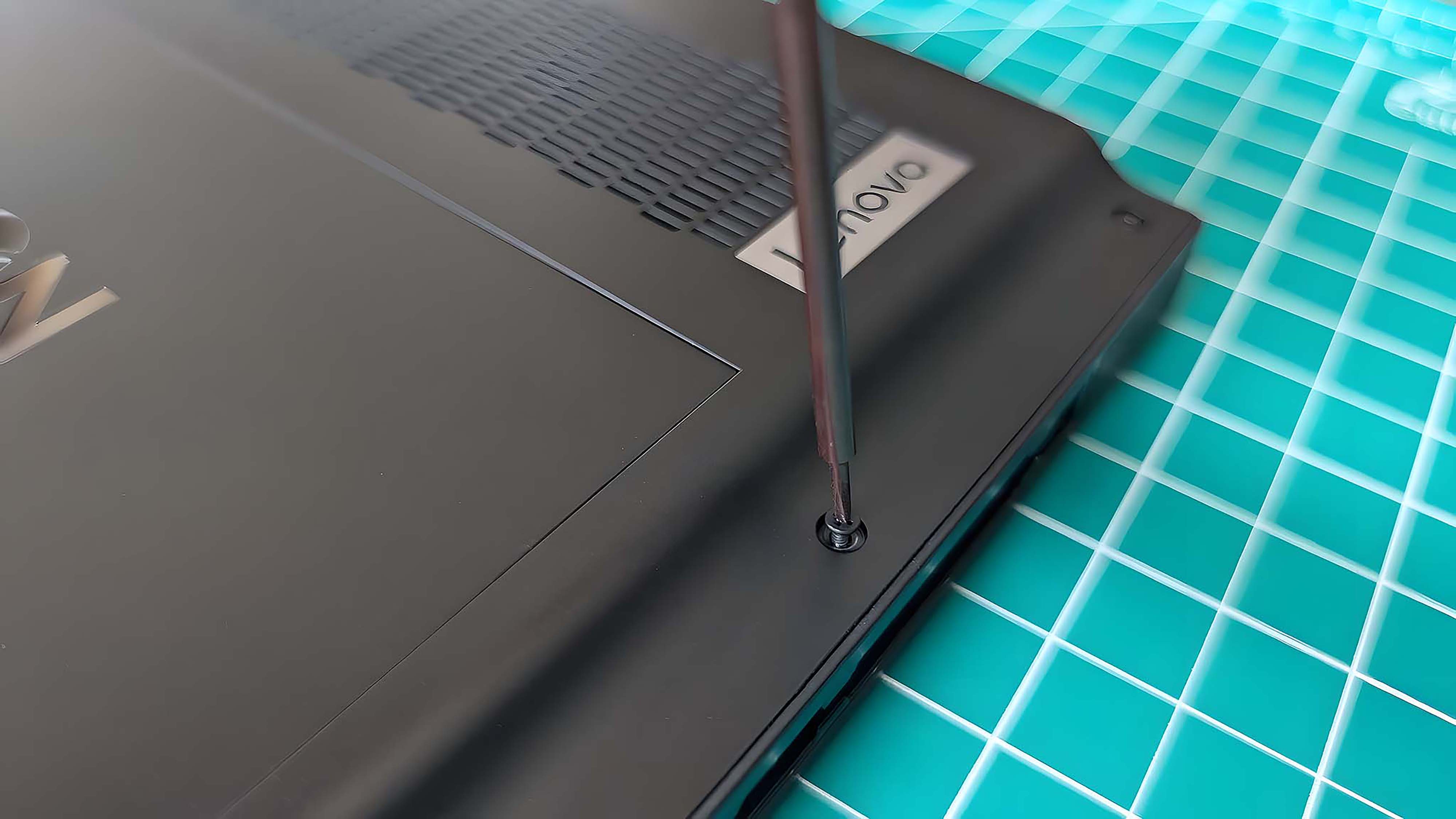 A screwdriver securing the Lenovo Legion Go back screw.
