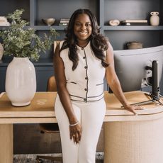 Jasmine Crockett posing in front of desk at home office.