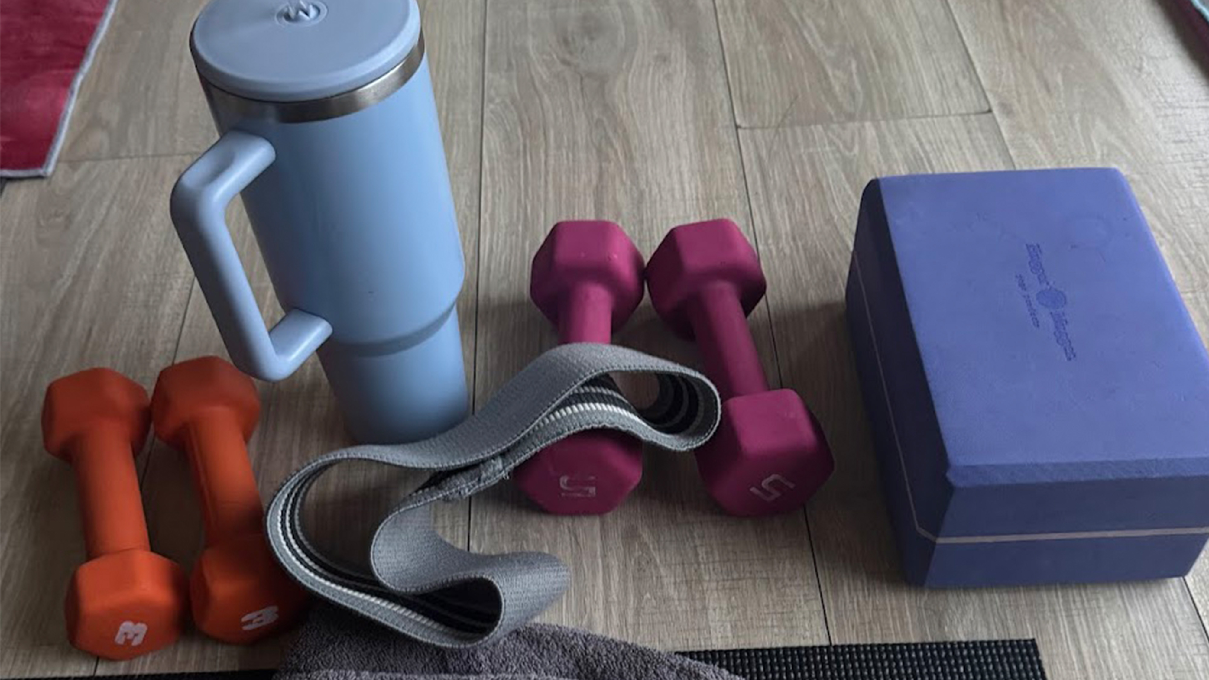 Workout gear and a water bottle sitting on the floor.