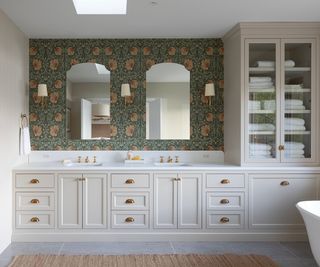 bathroom with two basins and patterned wallpaper