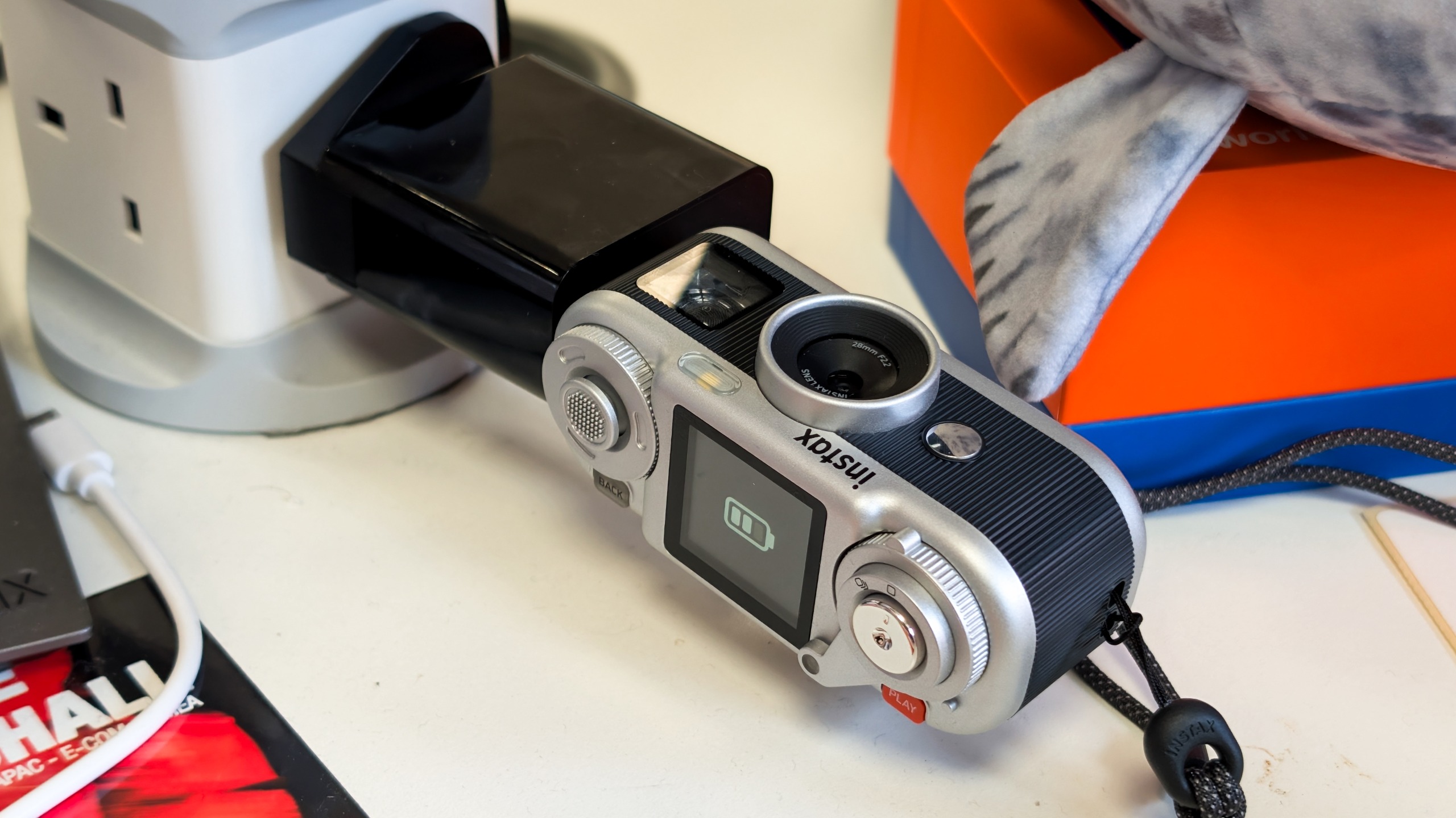 A black and silver Fujifilm Instax Pal 2 digital camera