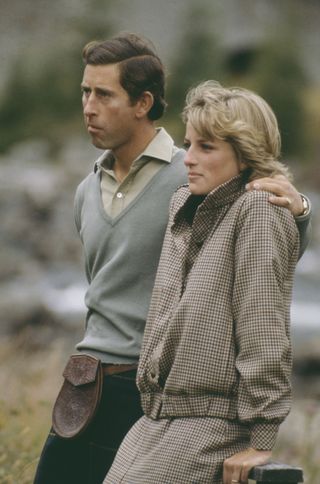 Prince Charles putting his arm around Princess Diana in Scotland on their honeymoon looking serious