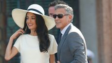 Amal Clooney wearing white sun hat