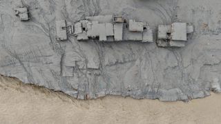 TOPSHOT - An aerial view shows houses lying deluged in sludge after flash floods at Devighat, Bidur Municipality in Nepal's Nuwakot district on August 27, 2026. Nepal's disaster agency said that 823 people remained out of contact on August 27, more than 24 hours after a deadly flood tore through the border region with Tibet. (Photo by Prabin RANABHAT / AFP via Getty Images)