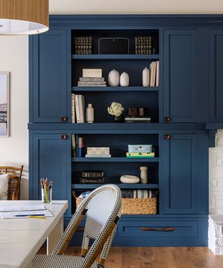 family room with blue alcove shelving and kitchen island with patterned bar stools