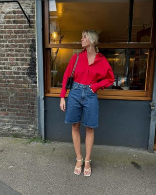 Tops to wear with shorts: @lindseyholland_ wears a red shirt with denim shorts