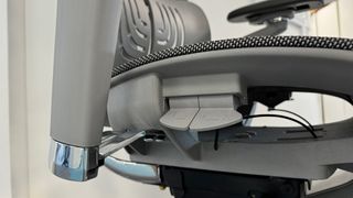 A close up of the Hinomi X1 chair, focusing on its many levers.