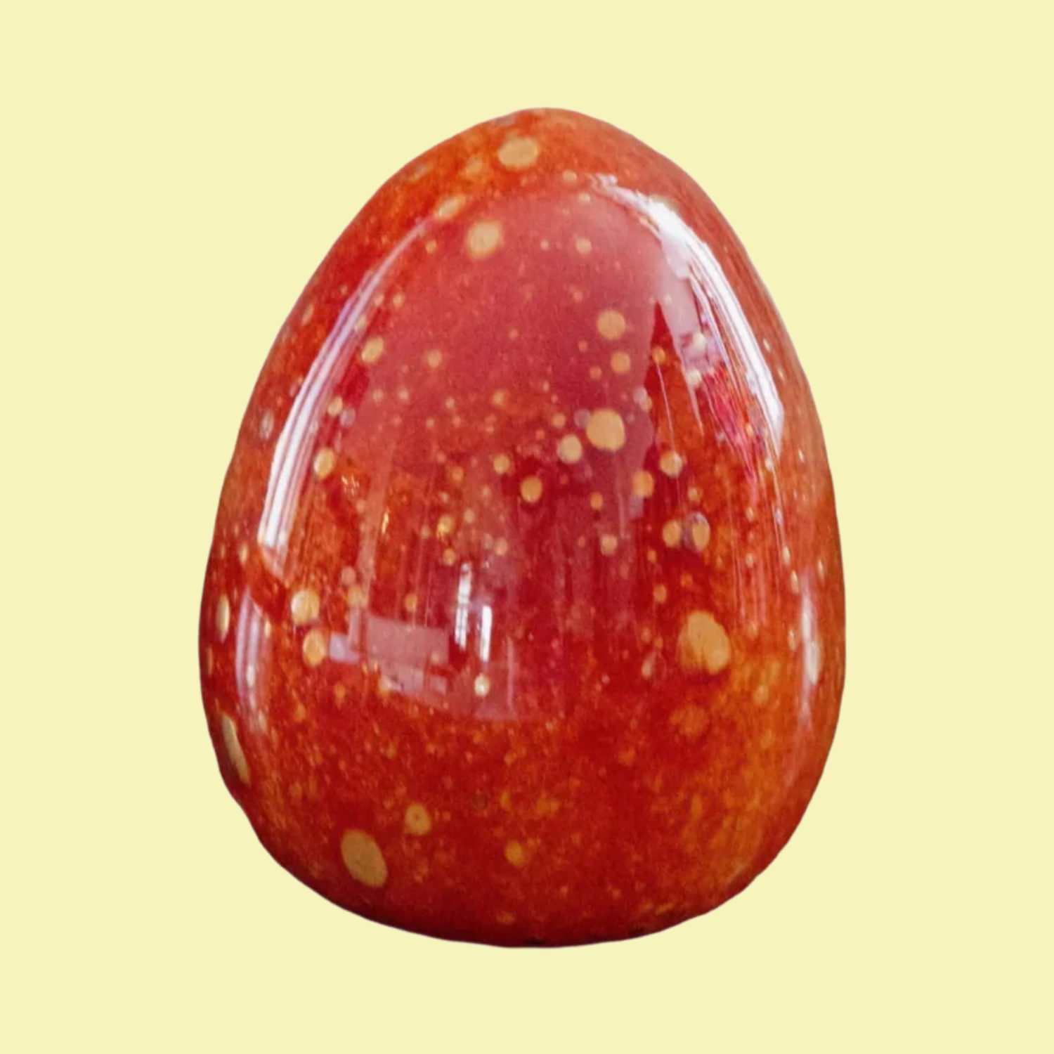 A glass red speckled egg