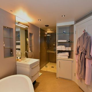 bathroom with open shelve and white bathtub