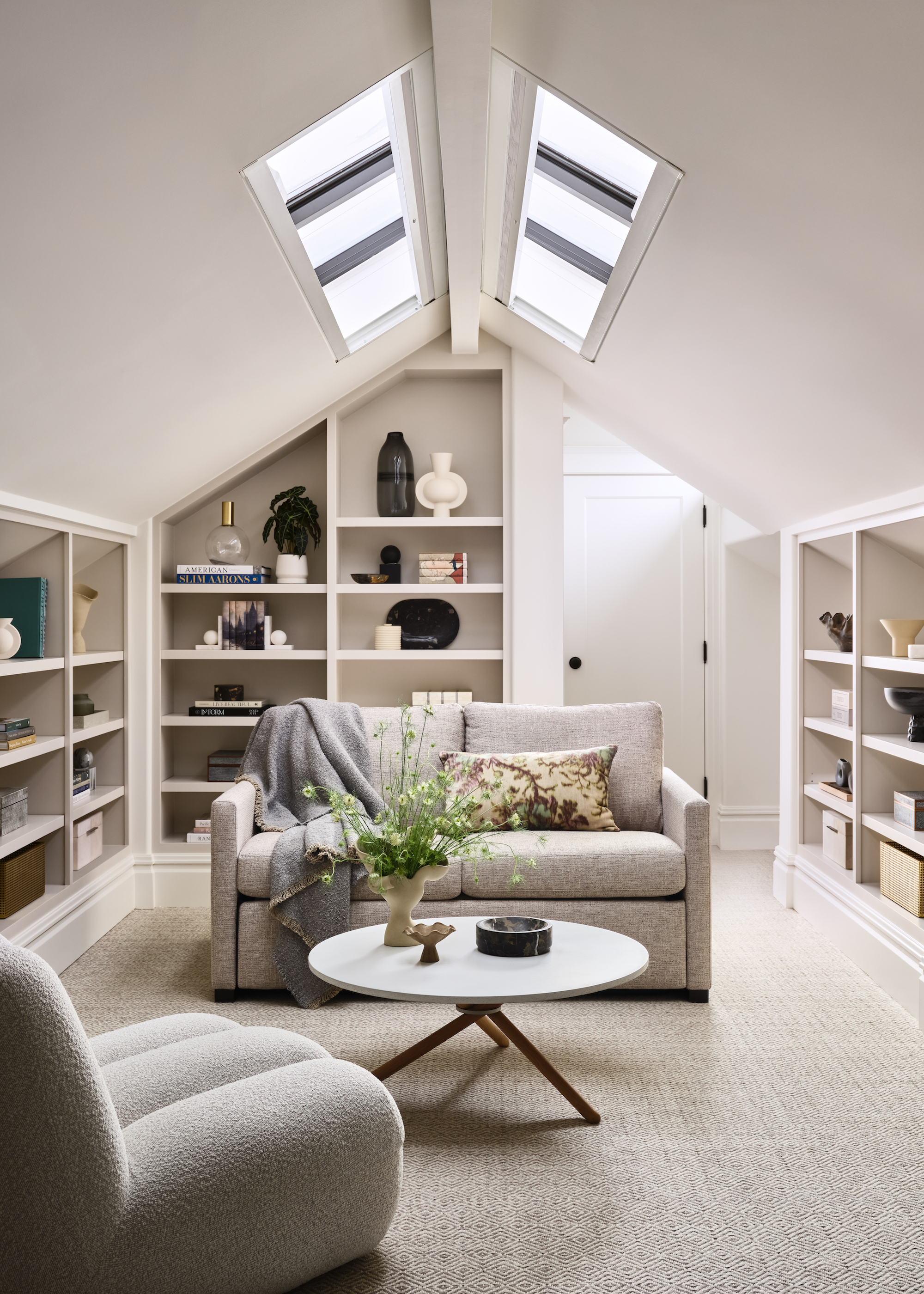 loft conversion with neutral palette, sofas and shelving