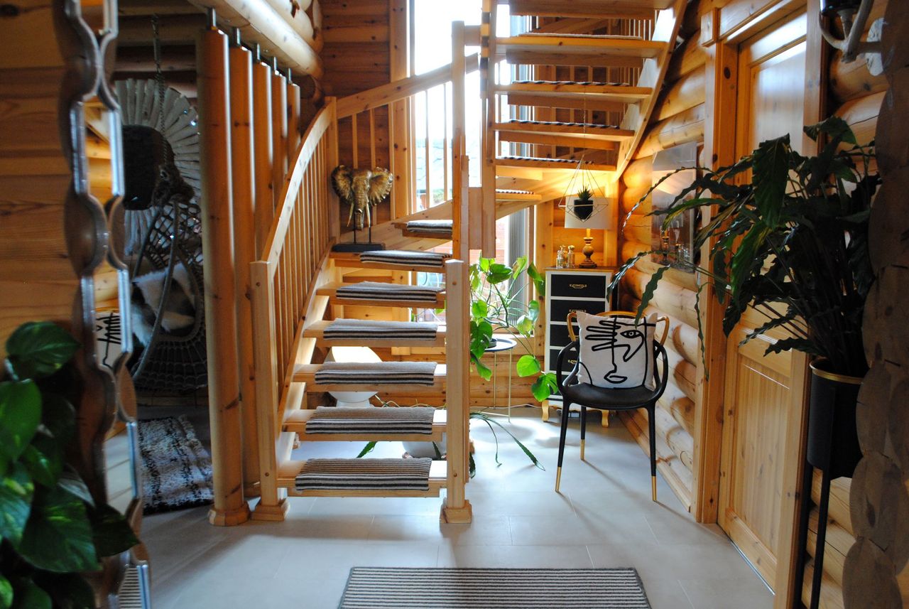 The wooden staircase which curves upstairs has individual carpeted flooring