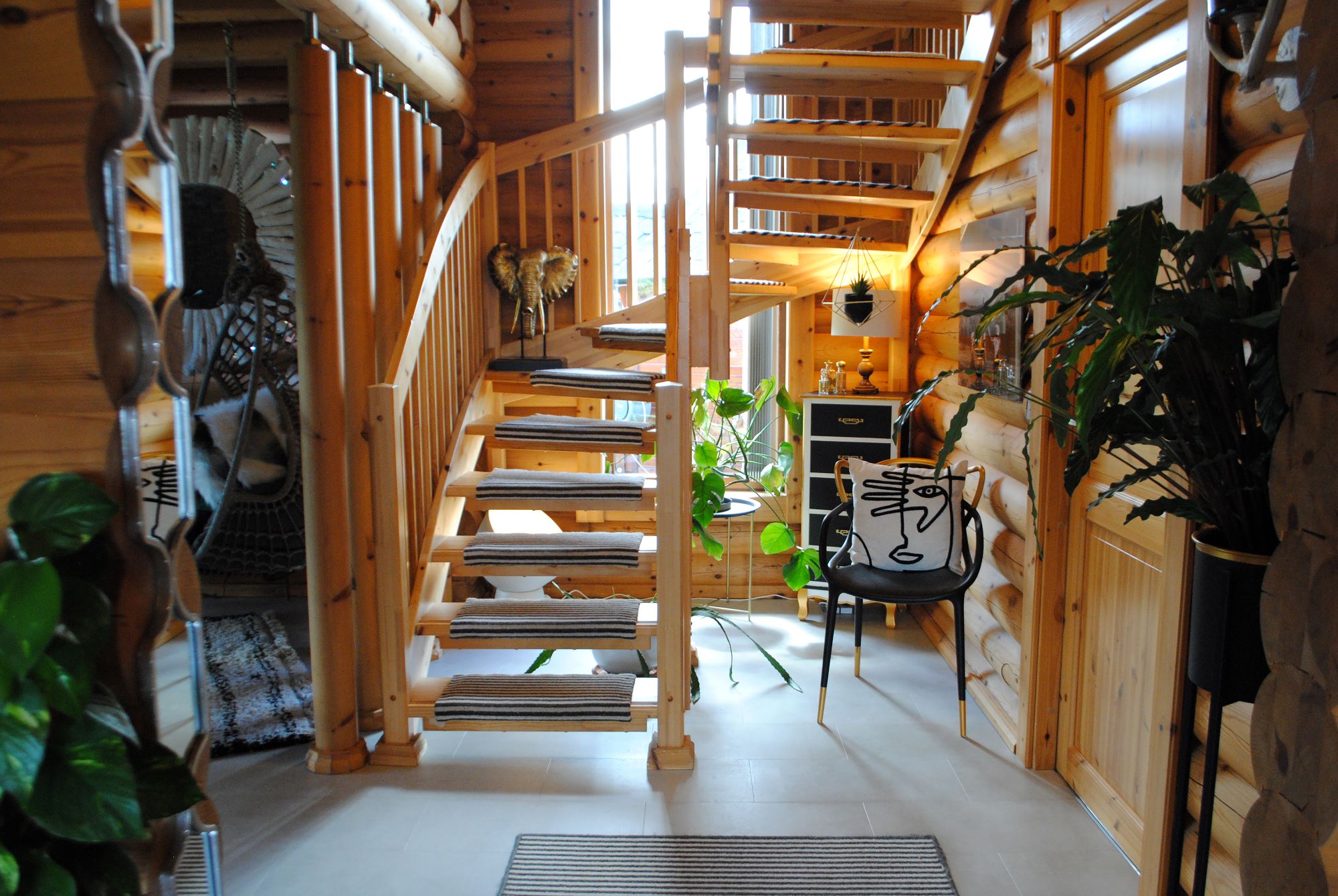 The wooden staircase which curves upstairs has individual carpeted flooring