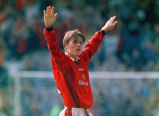 Manchester United's David Beckham celebrates after scoring his famous goal from the halfway line against Wimbledon, August 1996