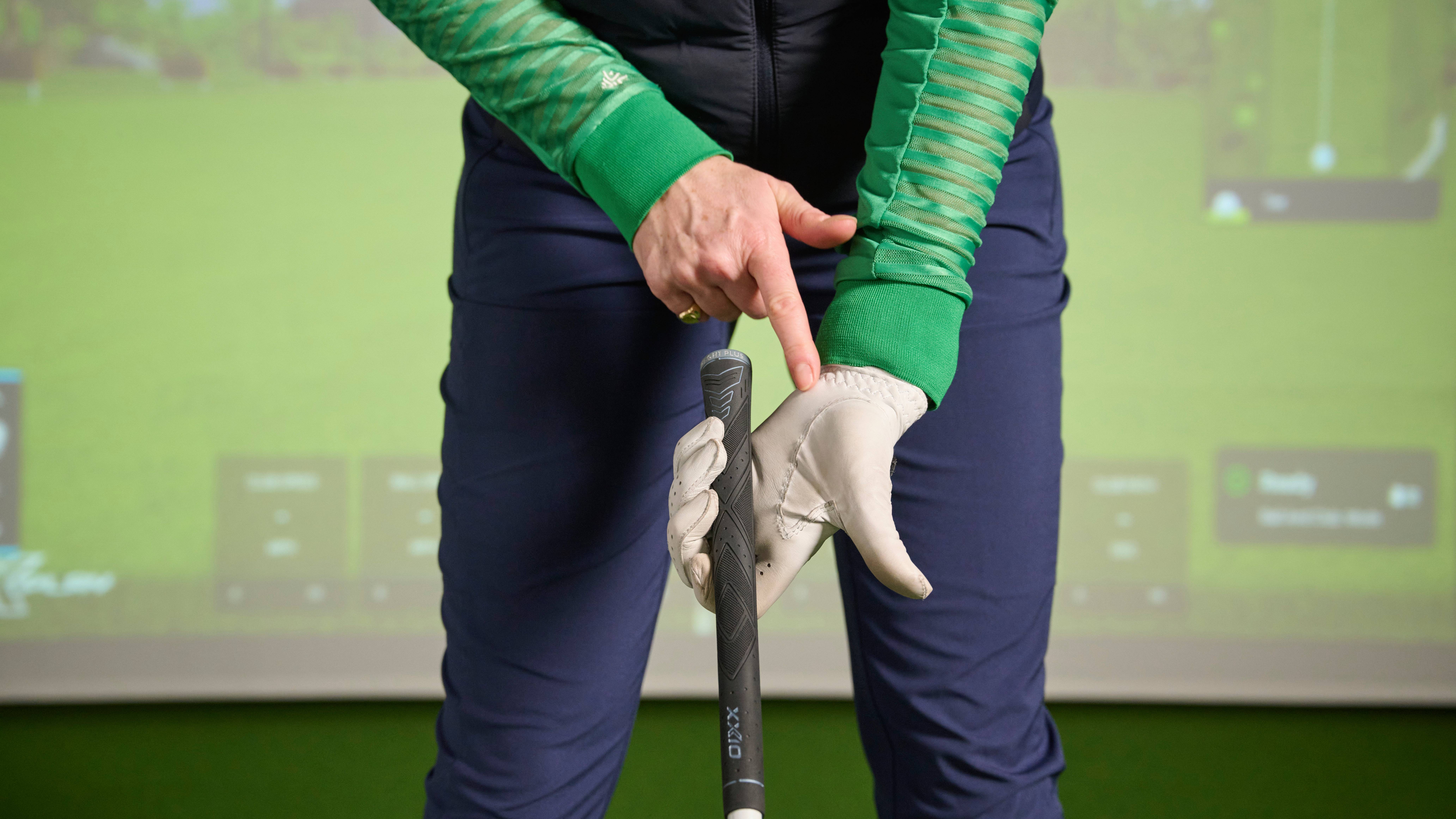 Katie Dawkins pointing out a poor grip where glove becomes worn