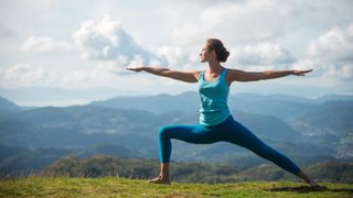 A woman doing yoga in the mountains