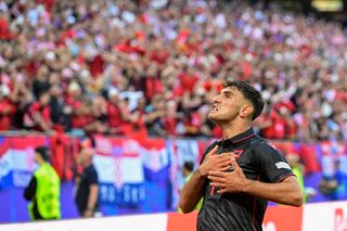 Albania's midfielder #14 Qazim Laci celebrates scoring the opening goal with fans during the UEFA Euro 2024 Group B football match between Croatia and Albania at the Volksparkstadion in Hamburg on June 19, 2024