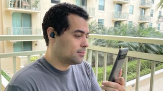 Our reviewer testing the Jabra Elite 4's call quality on his Google Pixel 6 Pro