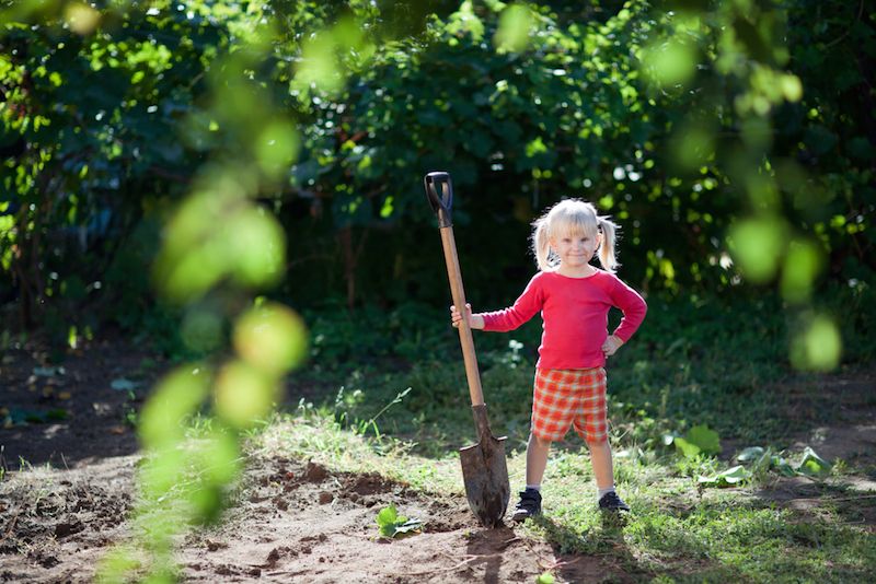 Girl with shovel on Earth Day