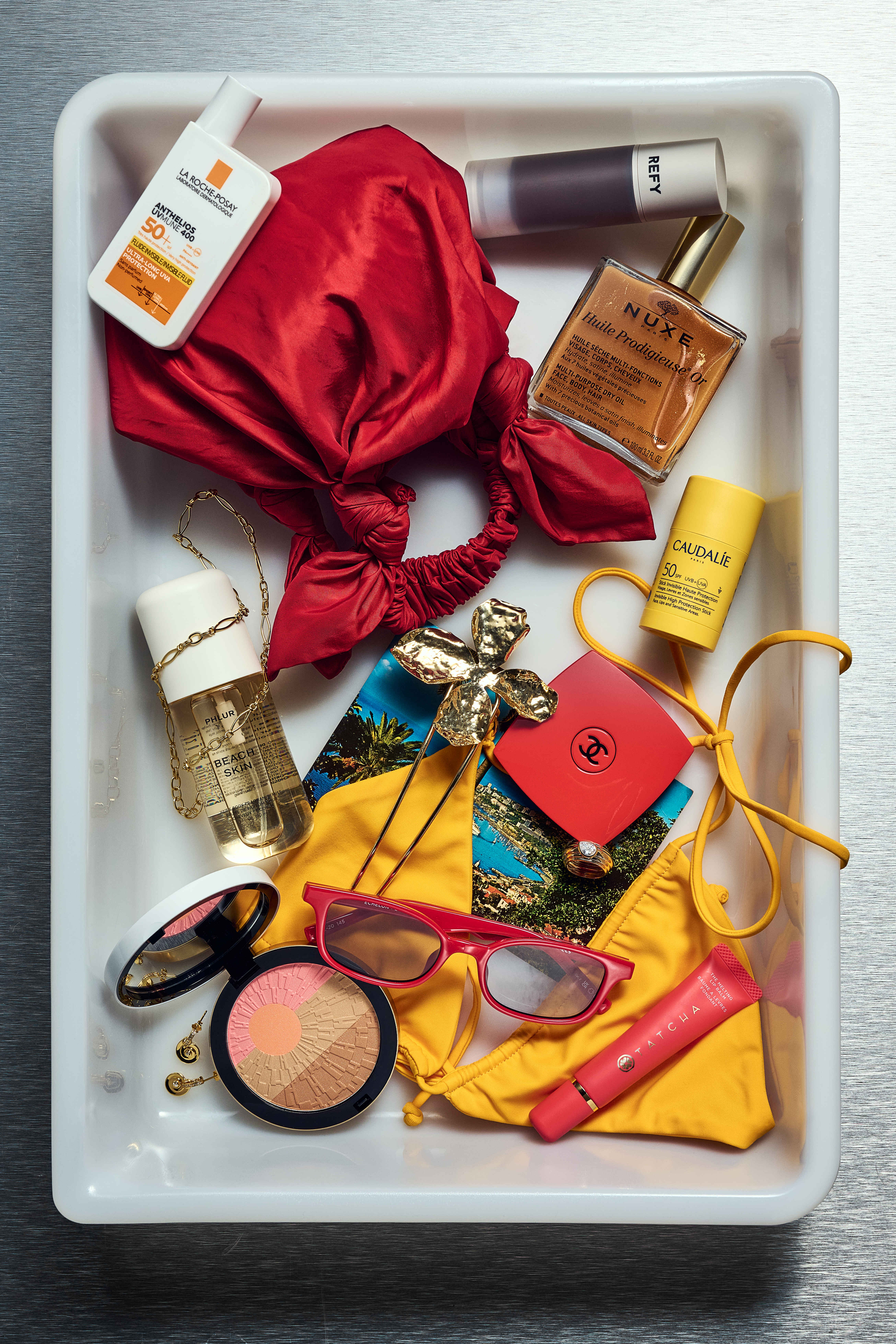 Brittany's airport tray, featuring red and yellow tones and Ibiza holiday aesthetic