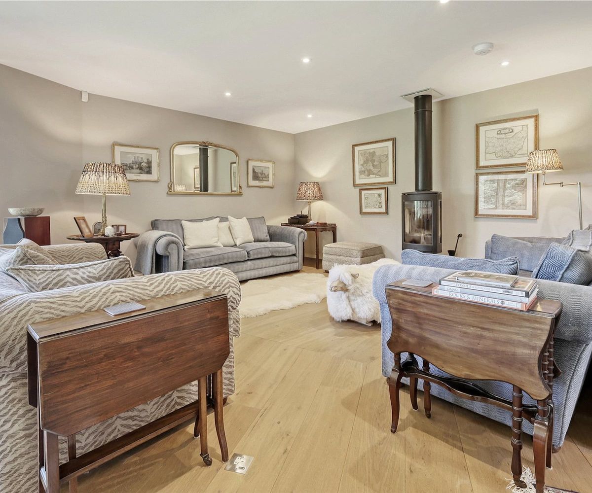 A living room with woodburner going to the ceiling