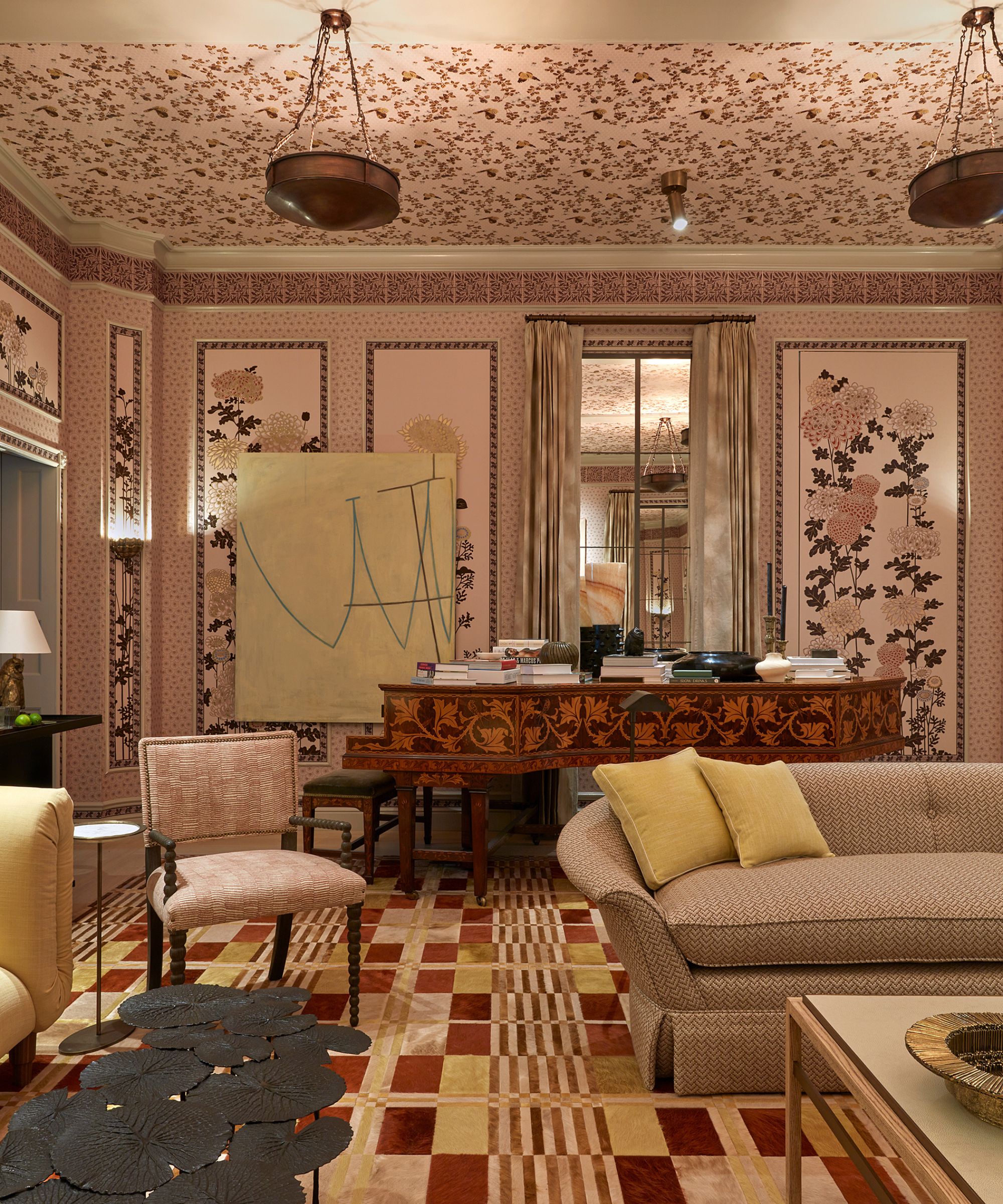 A grand drawing room with red patterned carpet and a grand piano