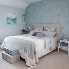 bedroom with frame on wall and grey coloured bedlinen