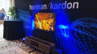 Harmon Kardon Enchant 1100 soundbar on shelf with Enchant subwoofer