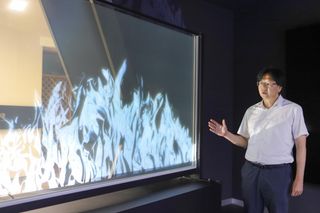 Principal Researcher Jun-Ho Jeong of the KIMM stands beside the transparent television.