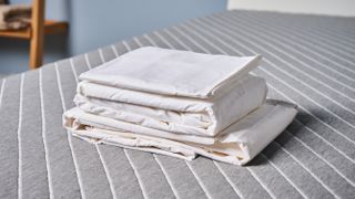Coop Percale sheet set bundle on the bed