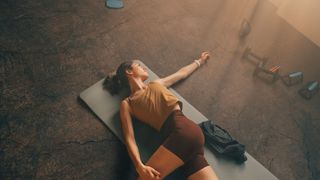 Woman lying down on her back stretching