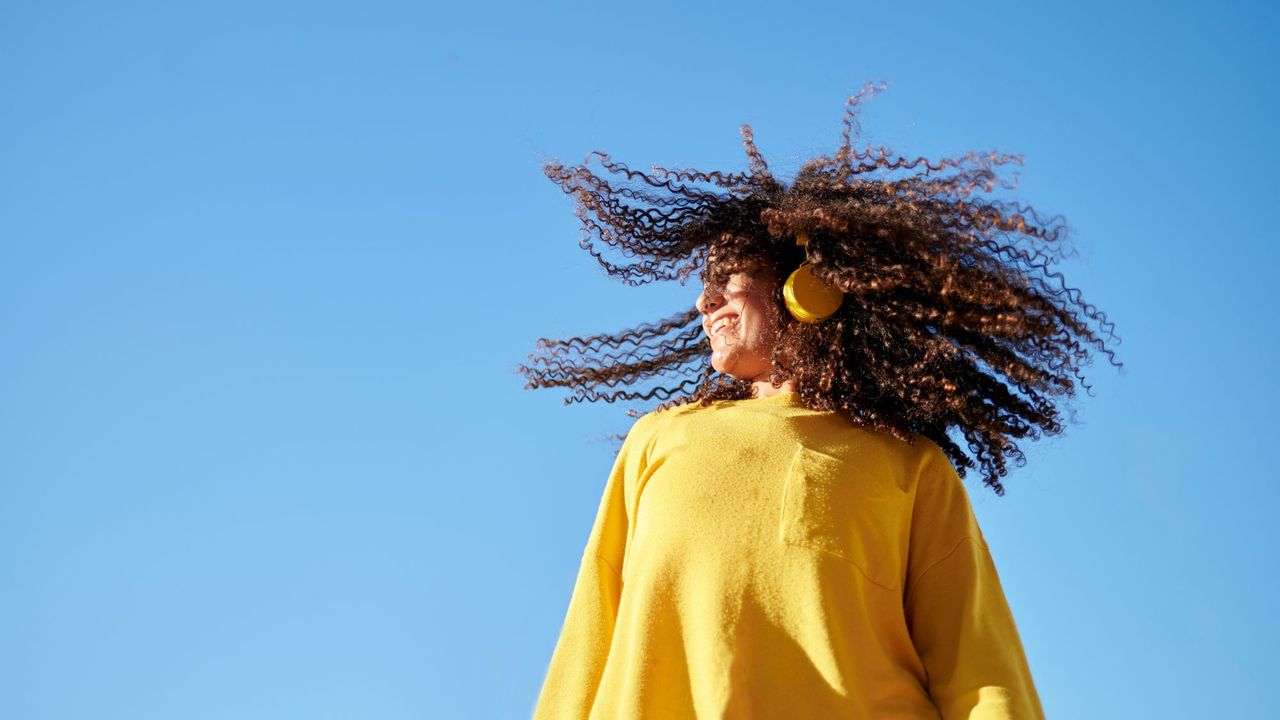 Woman listening to one of the best self care podcasts