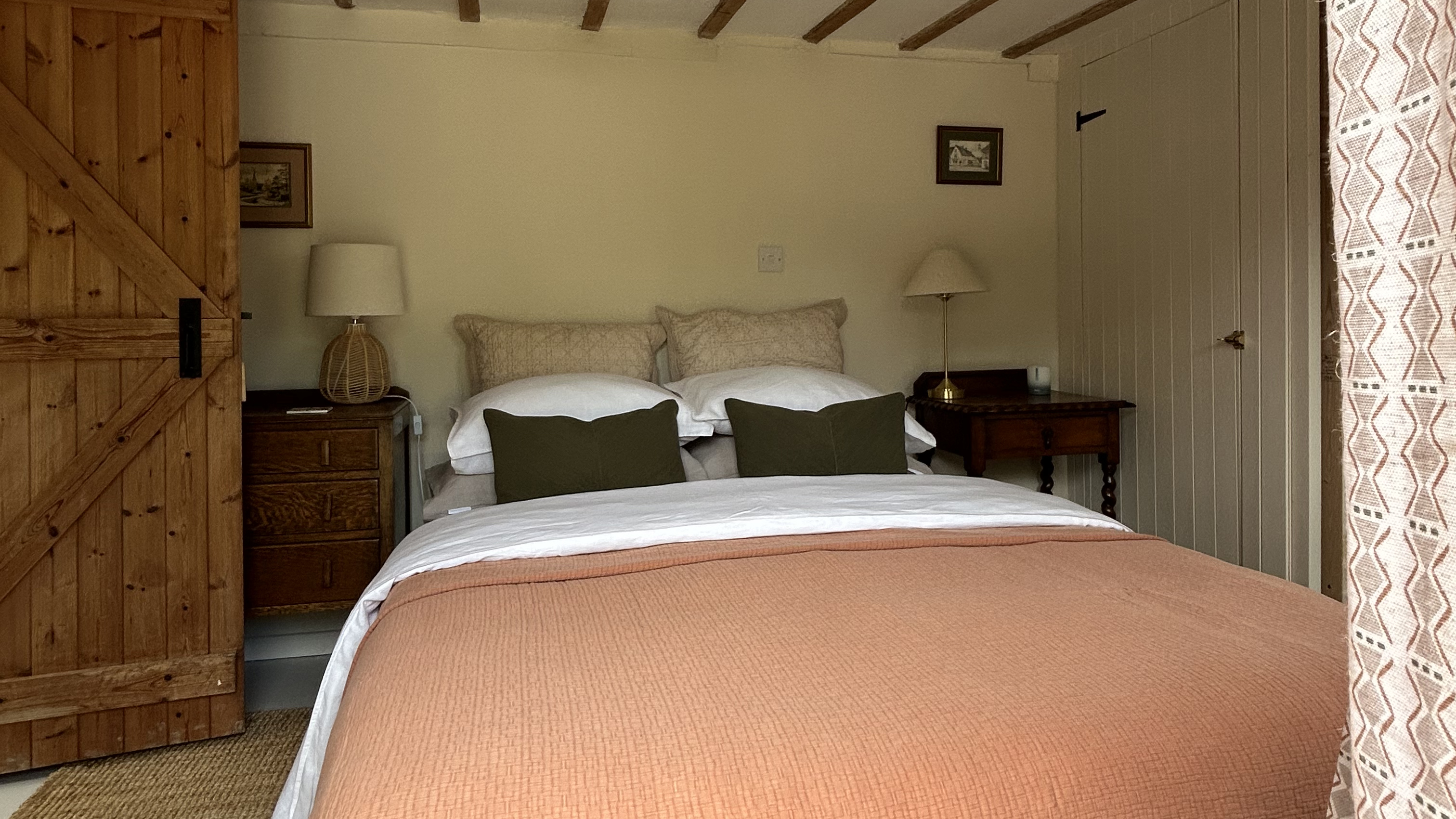 rustic bedroom with peach blanket on the bed