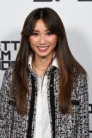 Brenda Song with long slightly layered hair.