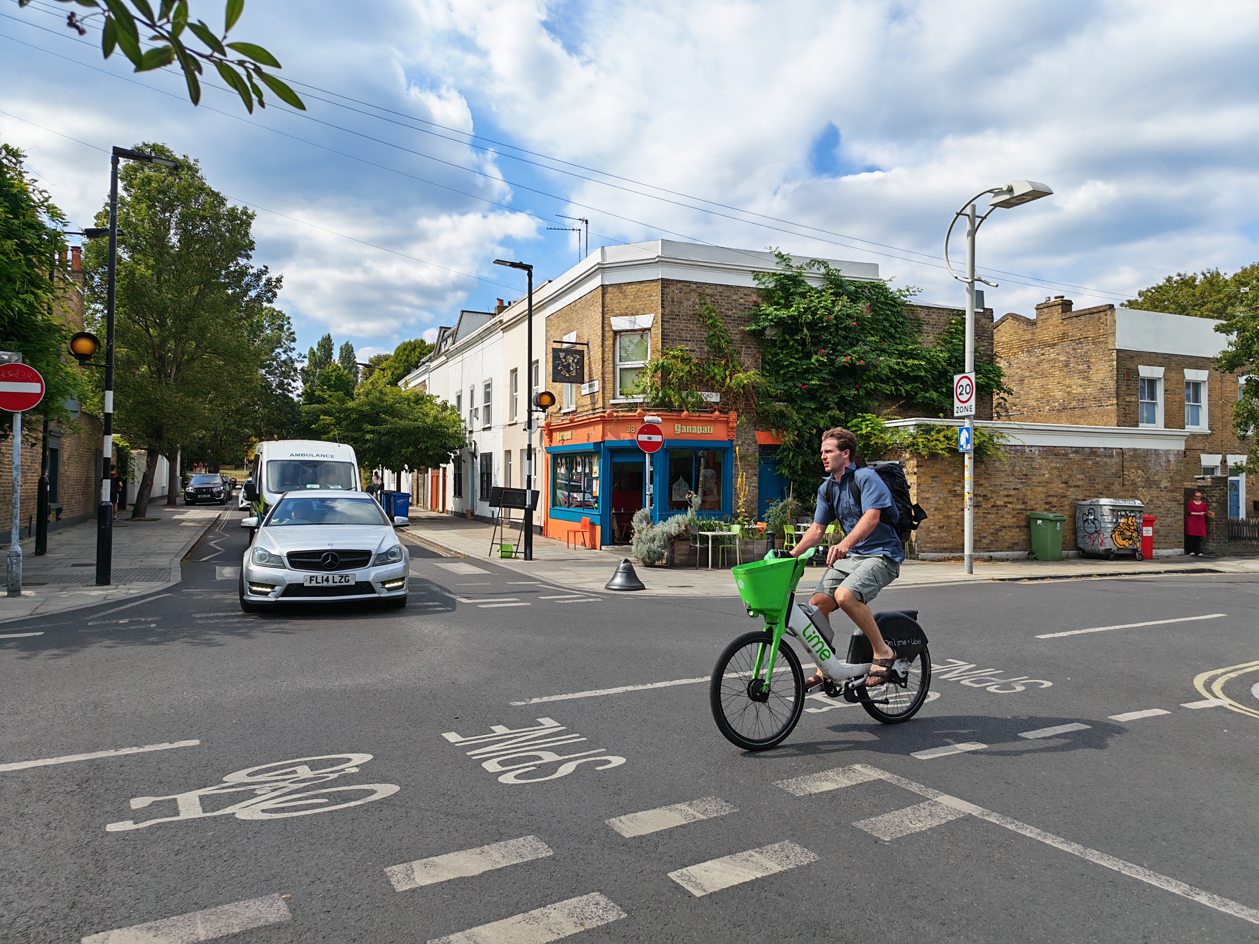 A crossroads with a man on an e-bike riding past