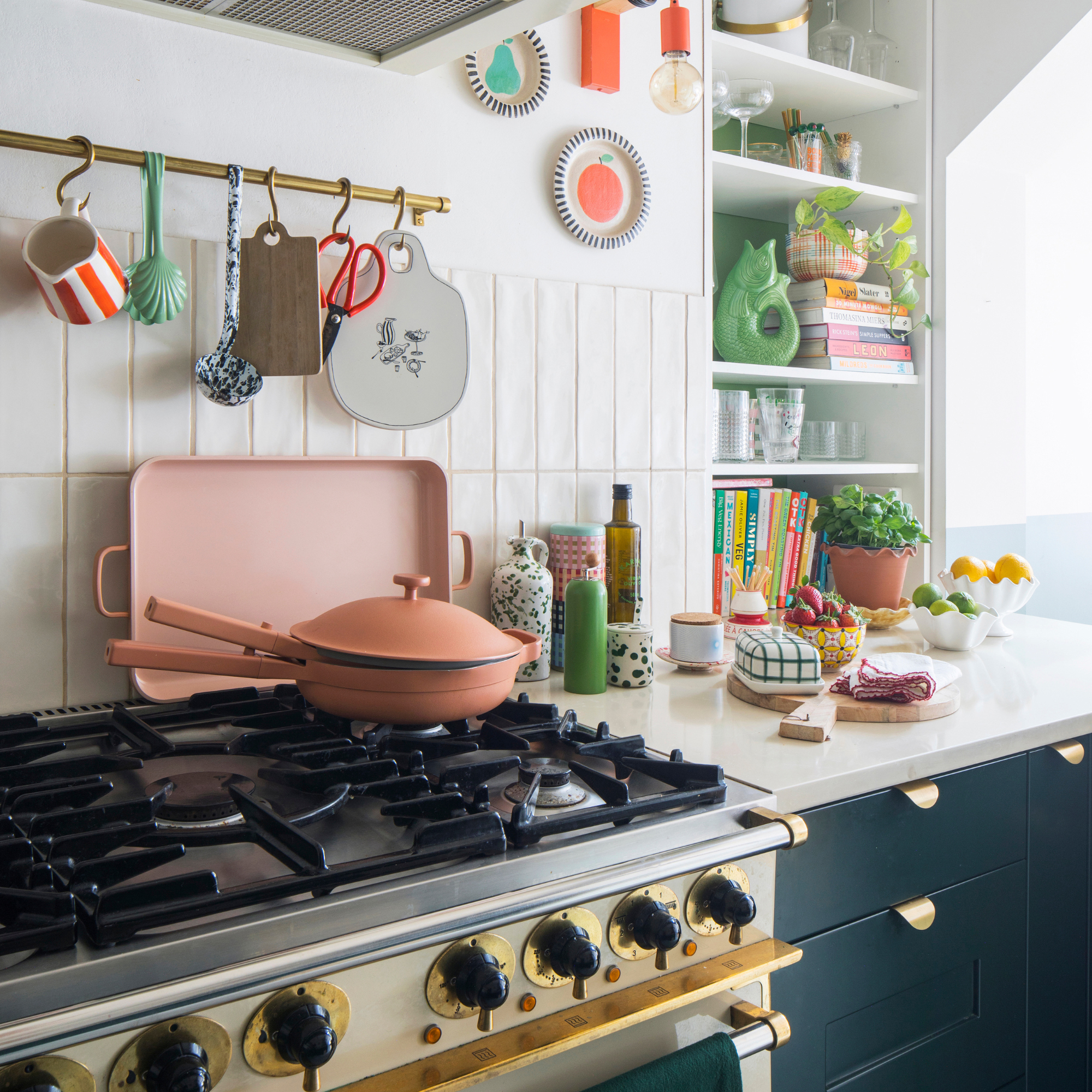 Our Place pan in rust on a hob in a modern kitchen.
