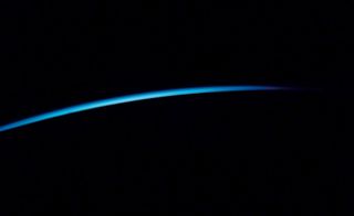 The elusive sliver of light from a shadowed Earth is one of space tourist Guy Laliberte's most prized photos among those he took from the International Space Station in 2009.