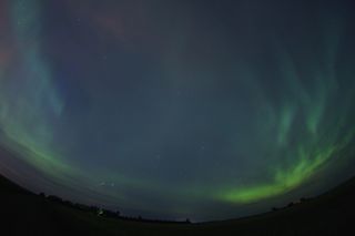 Skywatcher and photographer Colin Chatfield snapped this amazing aurora view on Aug. 5, 2011 from just outside Saskatoon in Saskatchewan, Canada, using a Canon 40D and Tokina 10-17mm fisheye lens. A meteor and eerie blue hue are visible in the upper left.
