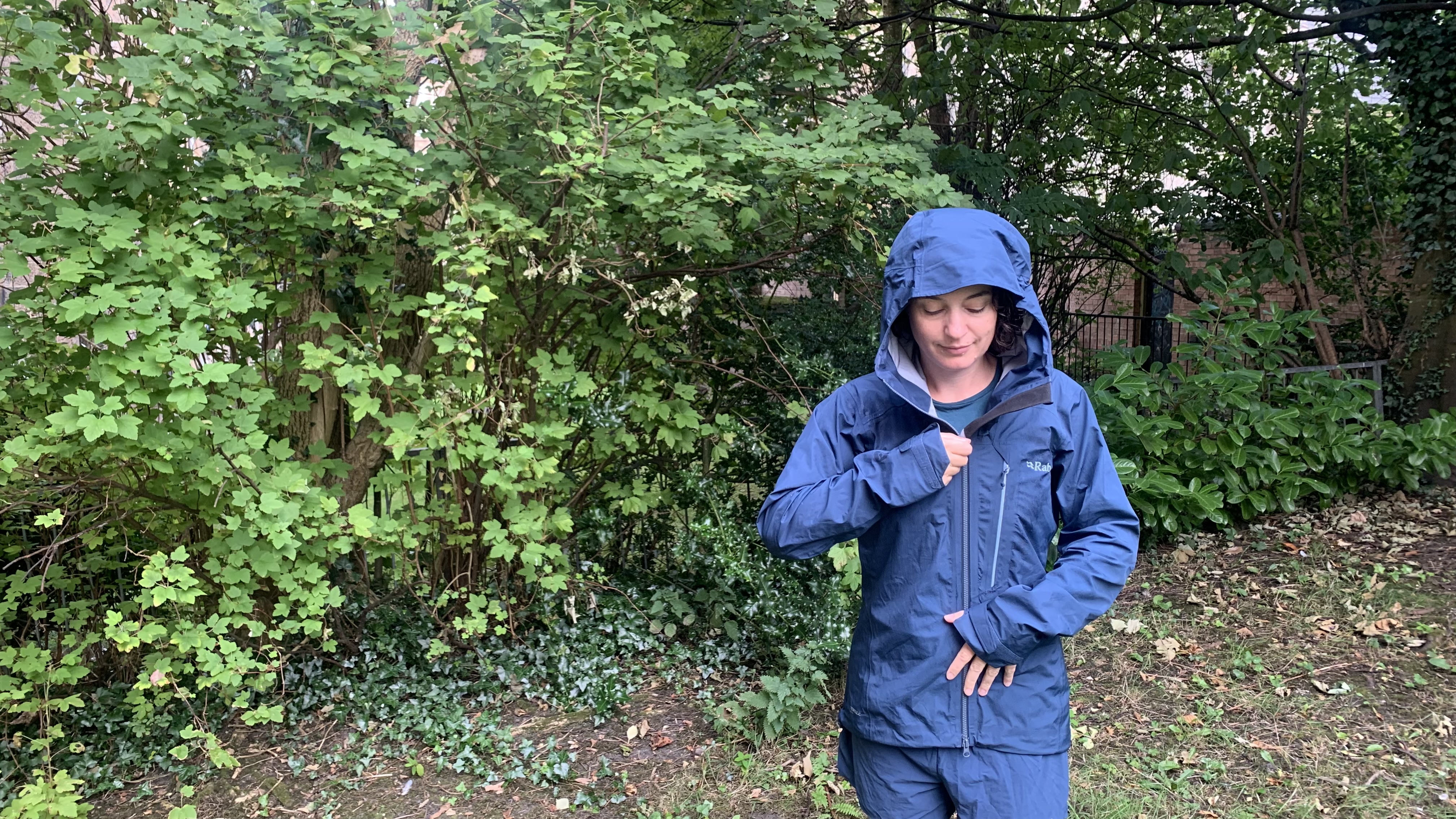 Julia Clarke zipping up the Rab Alpine Firewall Jacket