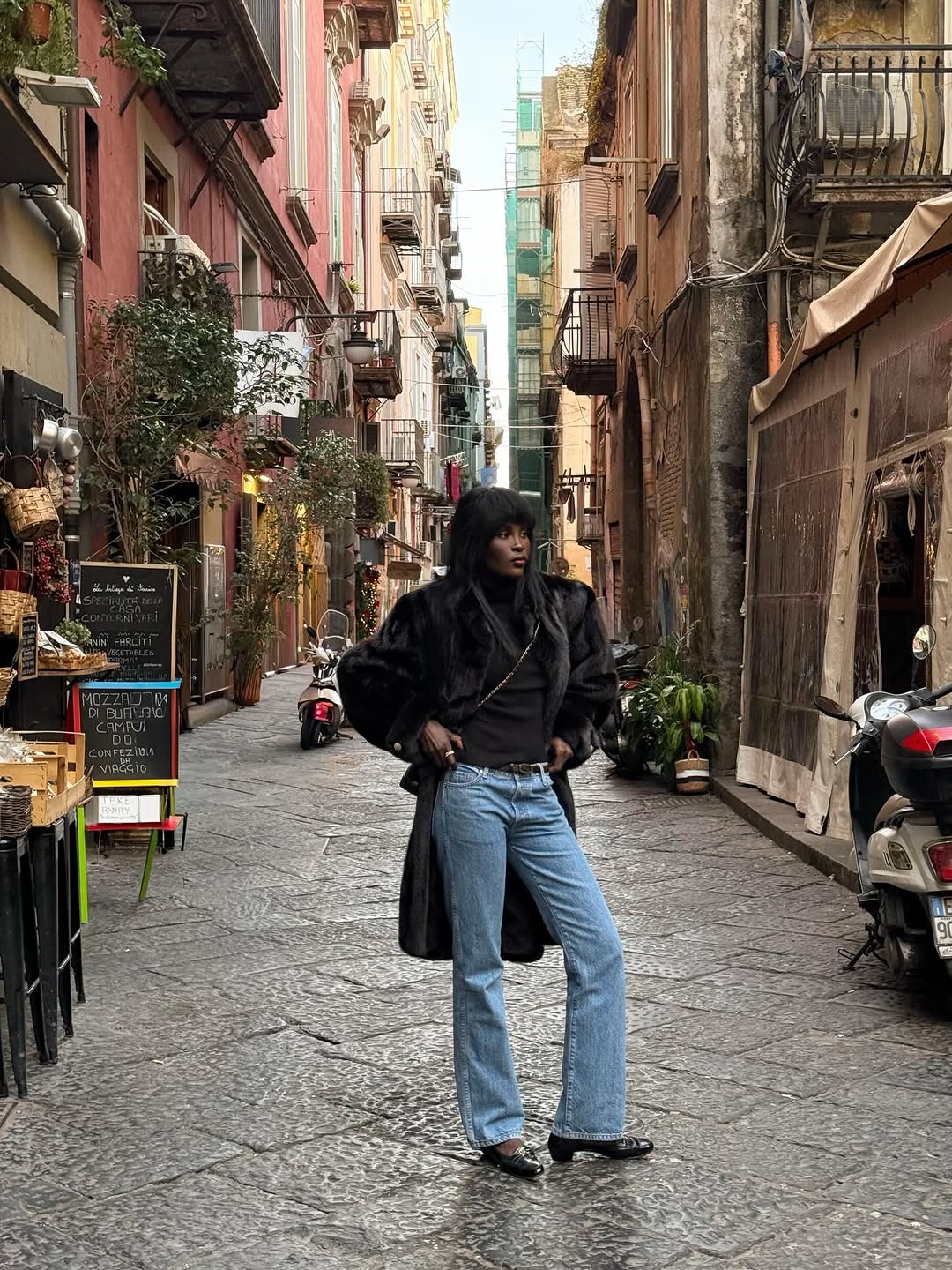 Woman wearing bootcut jeans with block-heel Mary Janes.