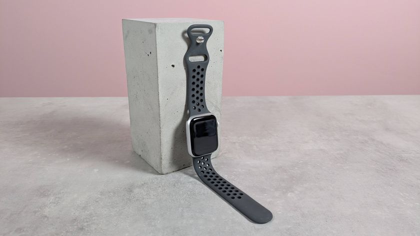 Upeak Sport Strap on Apple Watch, leaning on plinth on desk with pink background