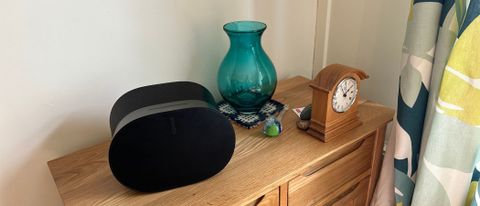 Sonos Era 300 on a sideboard with a vase and a clock